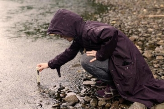 Water sample being taken in river