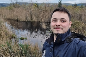 Photo of a man standing in a wetland