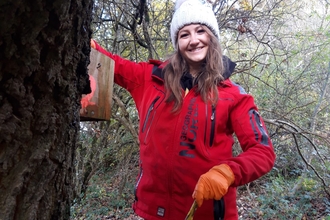 A photo of a girl and a nestbox