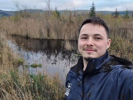 Photo of a man standing in a wetland