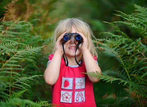 Girl with binoculars by David Tipling